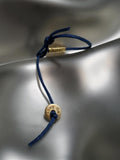 18K Gold "Om" Tube On Blue Cord Baby Bracelet